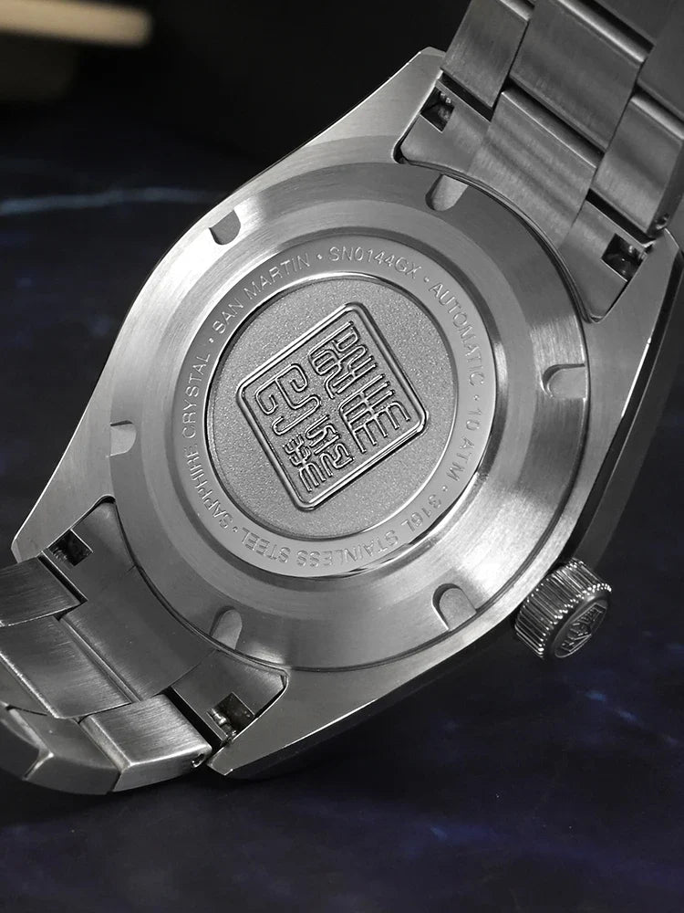 Close-up of San Martin JianZhan porcelain dial showing luminous BGW-X1 blue light hands and low-temperature enamel ceramic texture detail