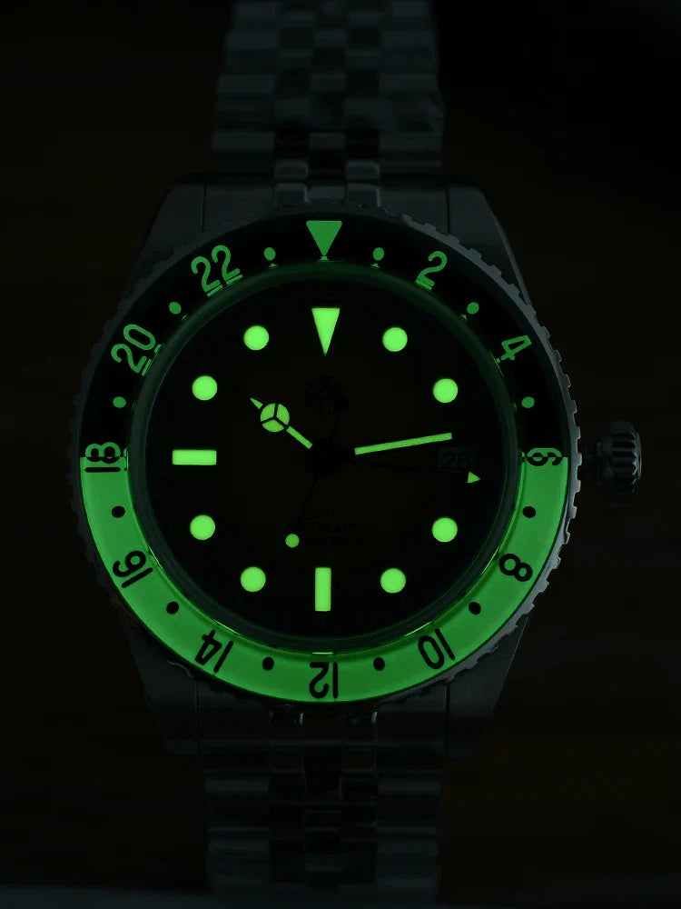 Green sandwich dial San Martin retro GMT shows date window and printed logo against the 40mm 316L stainless steel housing
