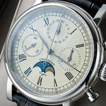 Close-up of Sugess M199S numberless dial showing subdials, moonphase window and applied indices beneath domed sapphire