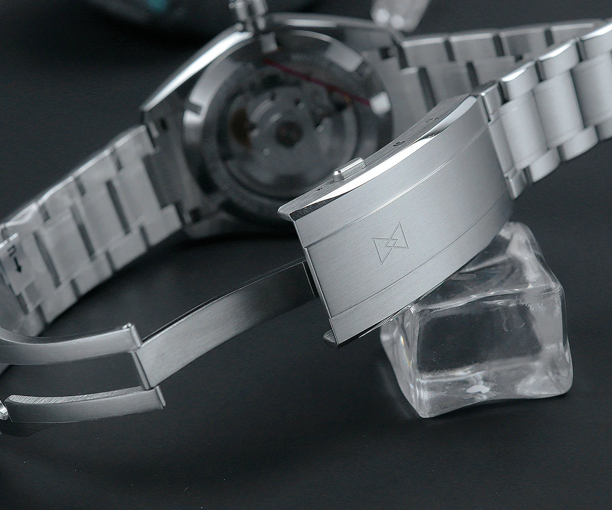 Close-up of the Cronos Arctic Ice texture dial with BGW-9 luminous hands and complete calendar complications visible