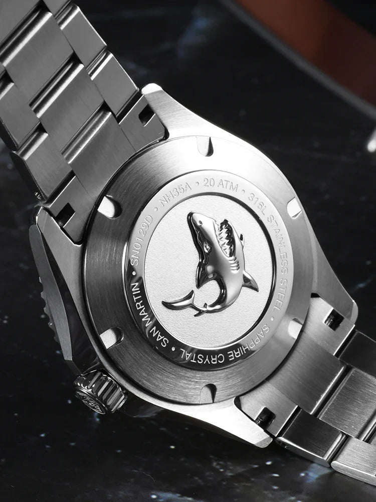 Close up of San Martin enamel sapphire diver screw down crown guard with hexagon logo and 3D shark case back detail