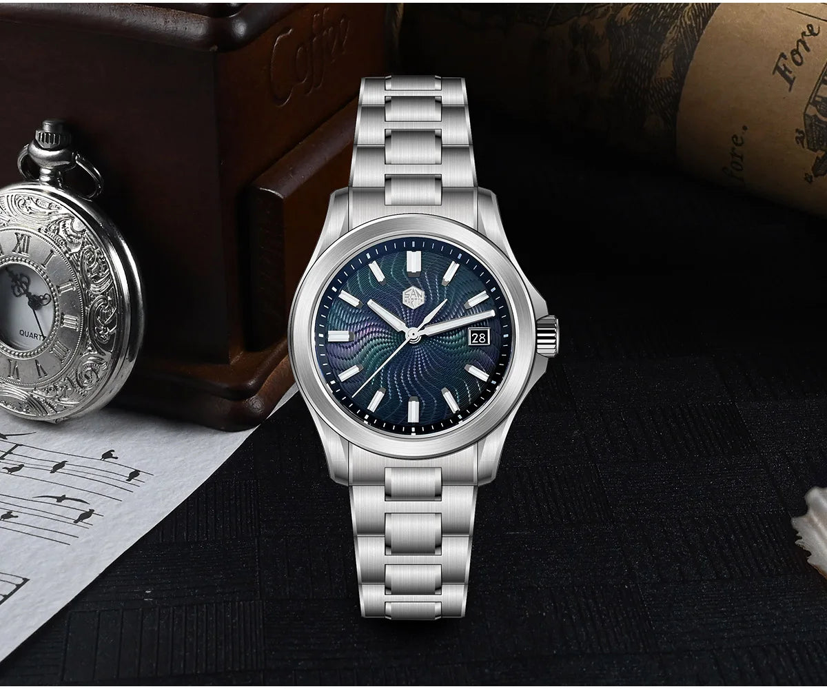 Blue-red gradient mother of pearl dial contrasts with brushed bracelet edges on San Martin SN0150-G1 mechanical watch